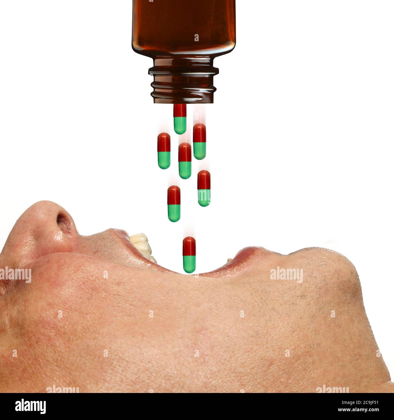 Person with mouth open swallowing capsules, , composite image. Stock Photo
