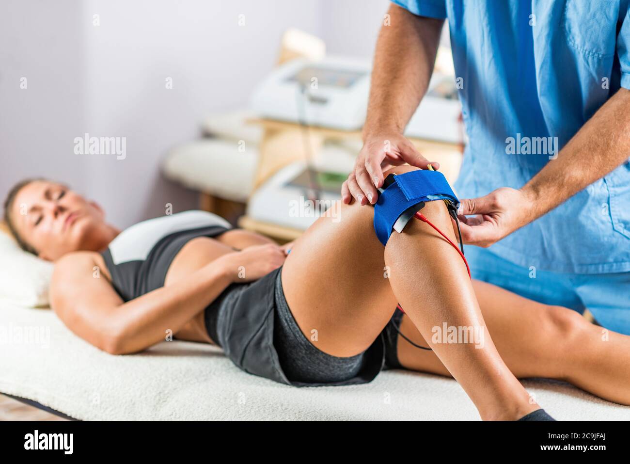 Muscle Stimulator Device With Electrodes Applied To Quadriceps By A  Professional Physiotherapist Stock Photo - Download Image Now - iStock