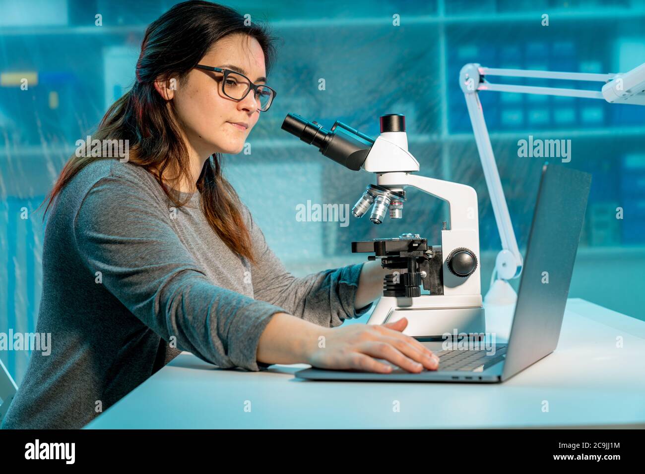 Student using microscope. Stock Photo