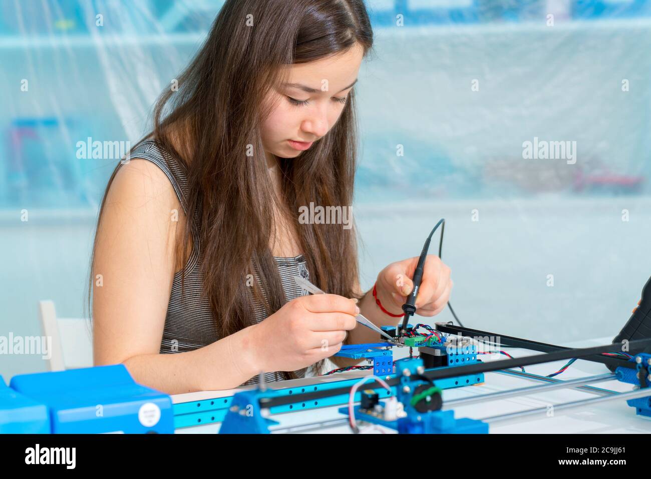 Girl working on robotics project. Stock Photo