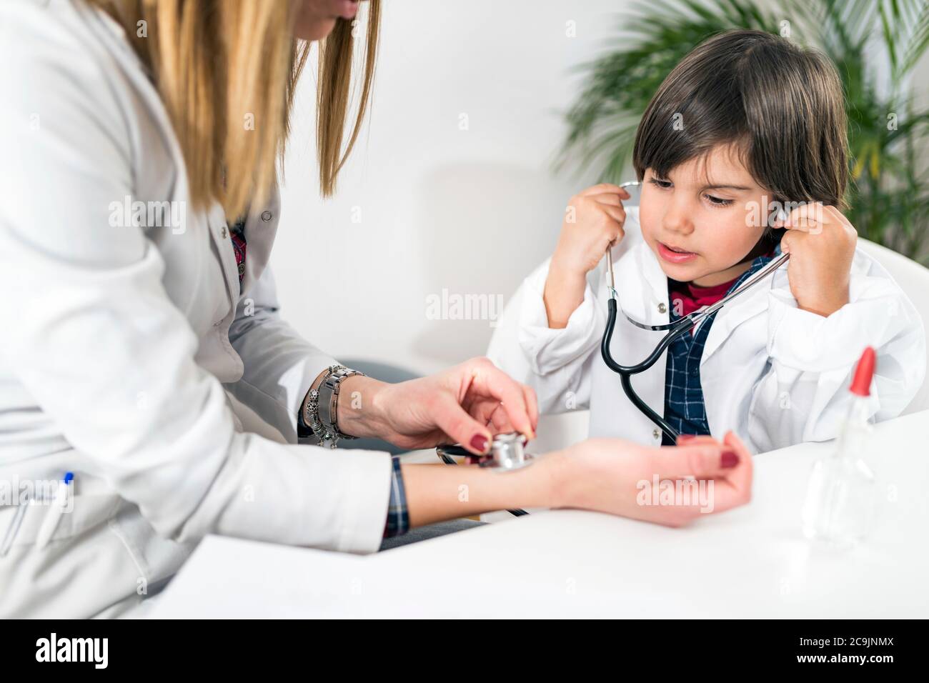 Little boy playing at being a doctor in a paediatrician's office. Stock Photo