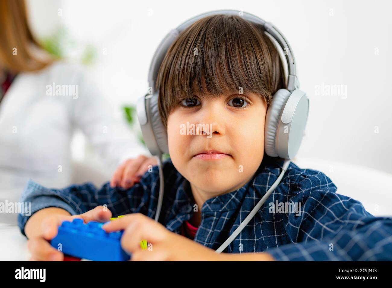 Paediatric hearing test. Boy wearing headphones, having a hearing test