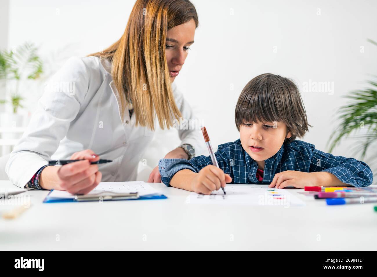 Psychology test for children. Toddler undergoing a logic test with numbers. Stock Photo