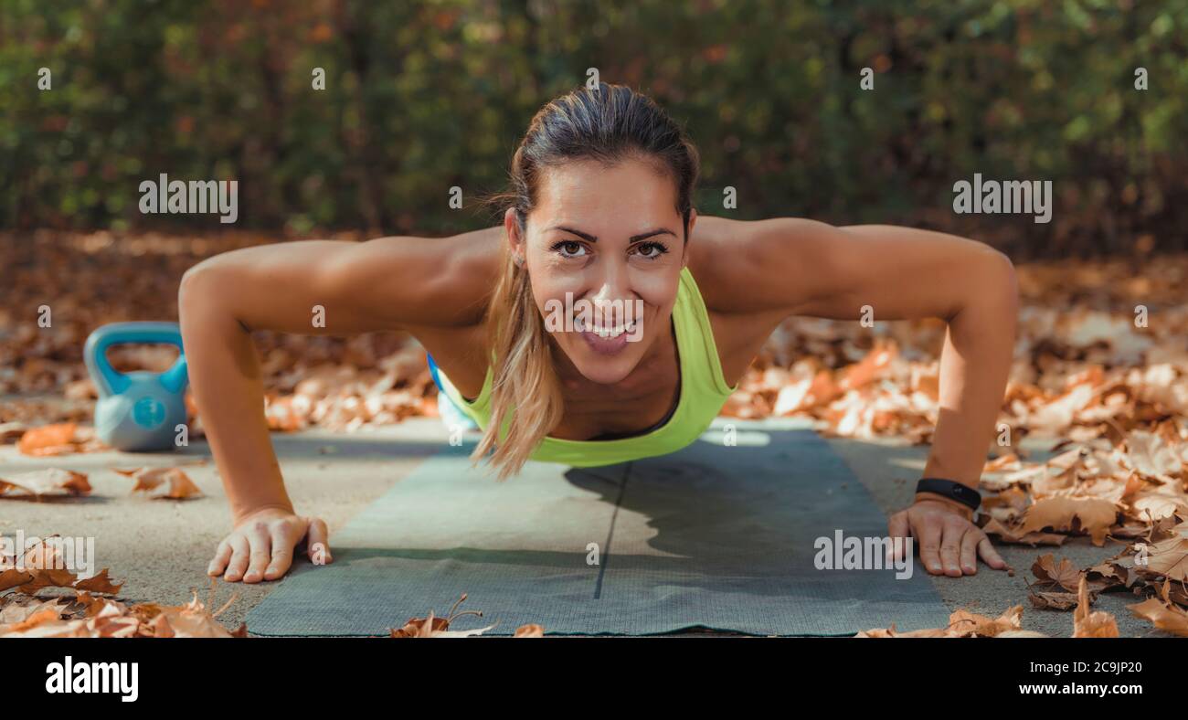 Doing push-ups. Hiit or high intensity interval training outdoors. Stock Photo