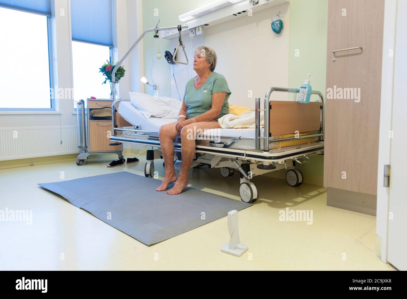 Geriatric hospital ward. Confused patient on the geriatric ward of a hospital. Stock Photo