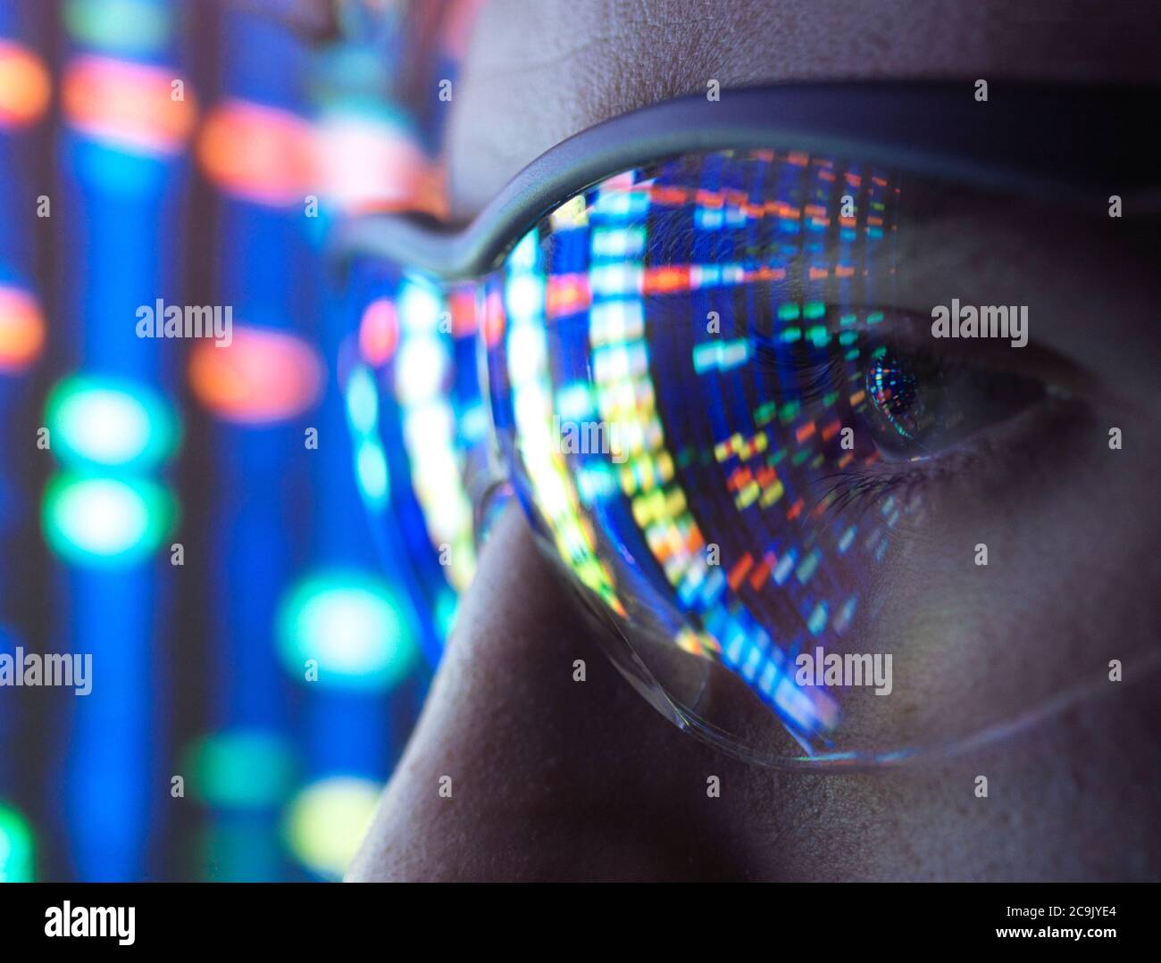 Scientist viewing DNA (deoxyribonucleic acid) profiles. Stock Photo