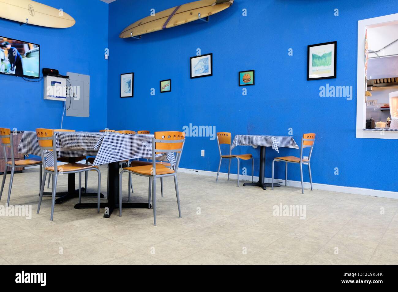 Interior of Surfside Burger Shack in Eureka, California set-up for indoor dining under Covid-19 government requirements; discontinued table settings. Stock Photo