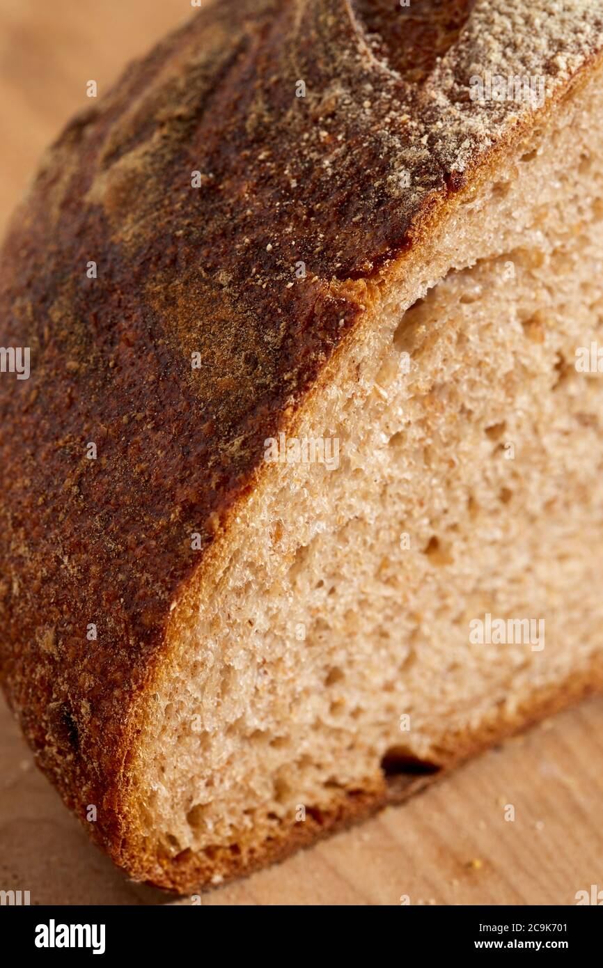 Loaf of sourdough, whole grain bread sliced open to reveal the inner crumb. Pennsylvania, USA Stock Photo