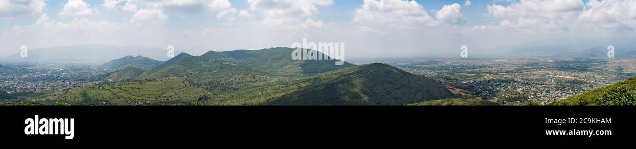 The ruins of Monte Alban are on the top of the long ridge, as viewed from the ruins of the Zapotec city of Atzompa, near Oaxaca, Mexico. The city of O Stock Photo