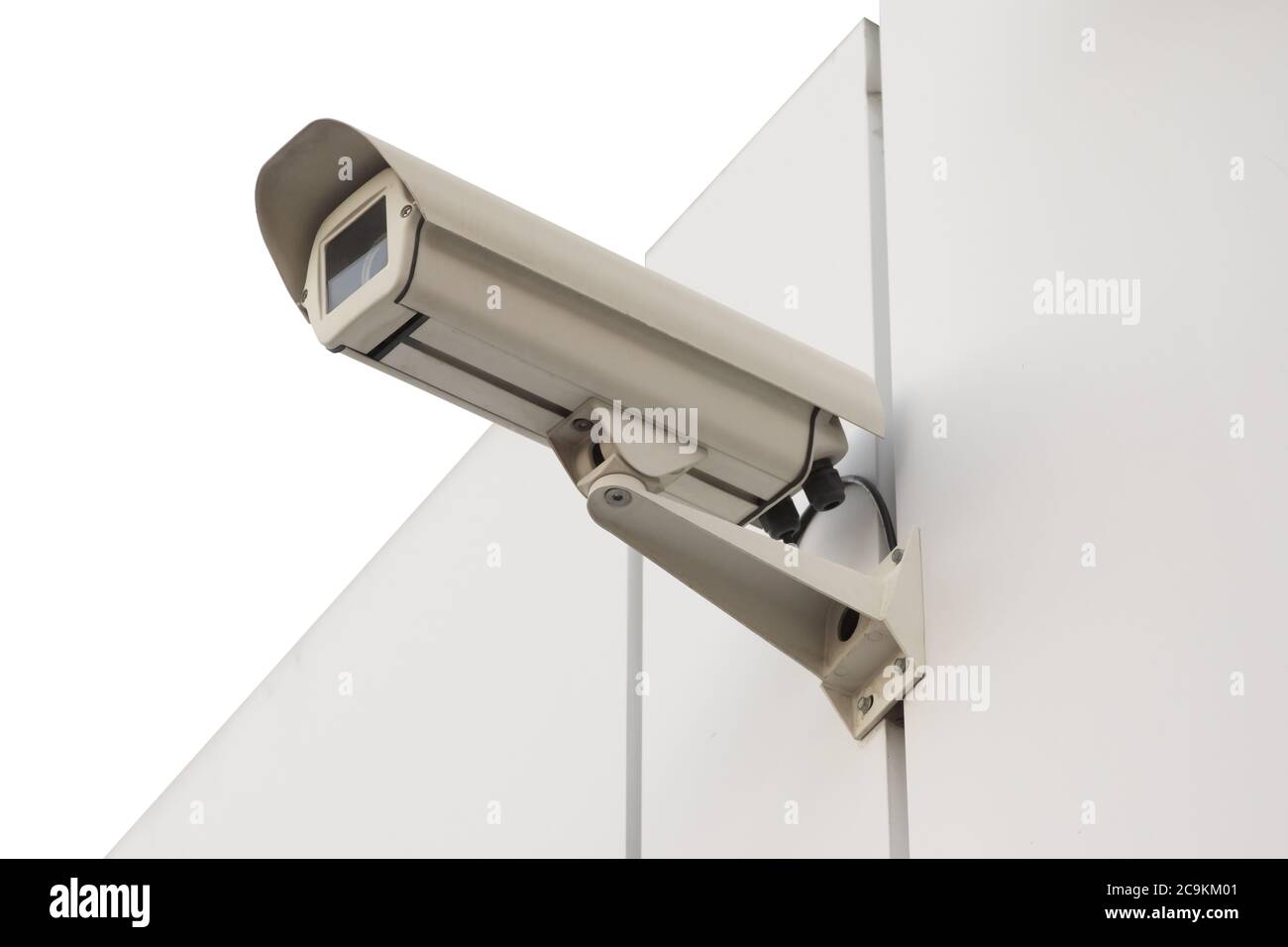 Security camera isolated on white wall. Isolated object. Stock Photo