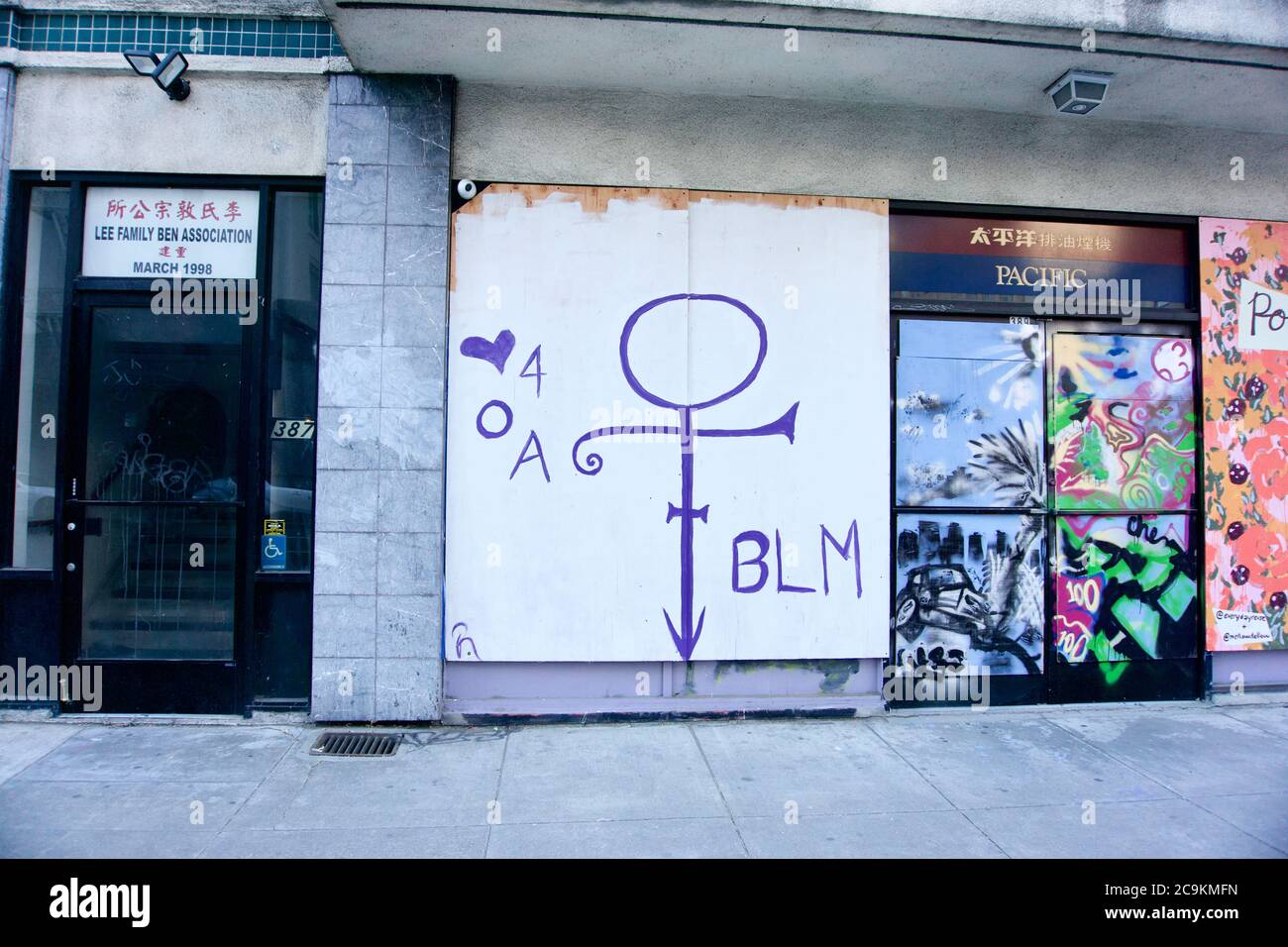 Prince love symbol painted on boarded storefront that reads BLM in honor of George Floyd and Black Lives Matter protests. Chinatown, Oakland, CA Stock Photo