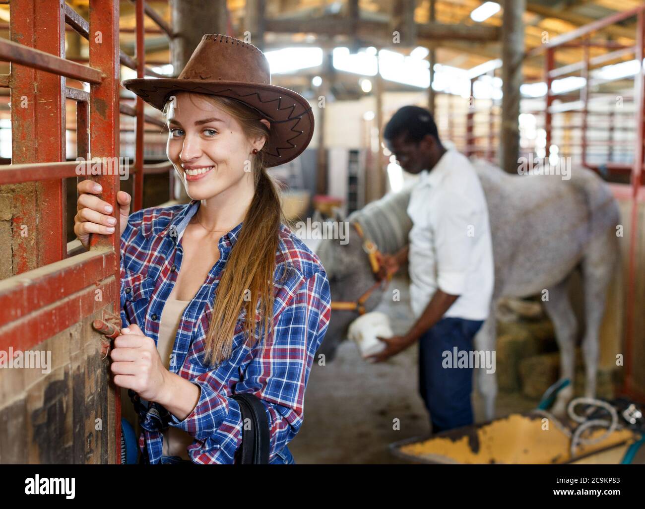 Portrait of girl farm worker standing at horse stable Stock Photo Alamy