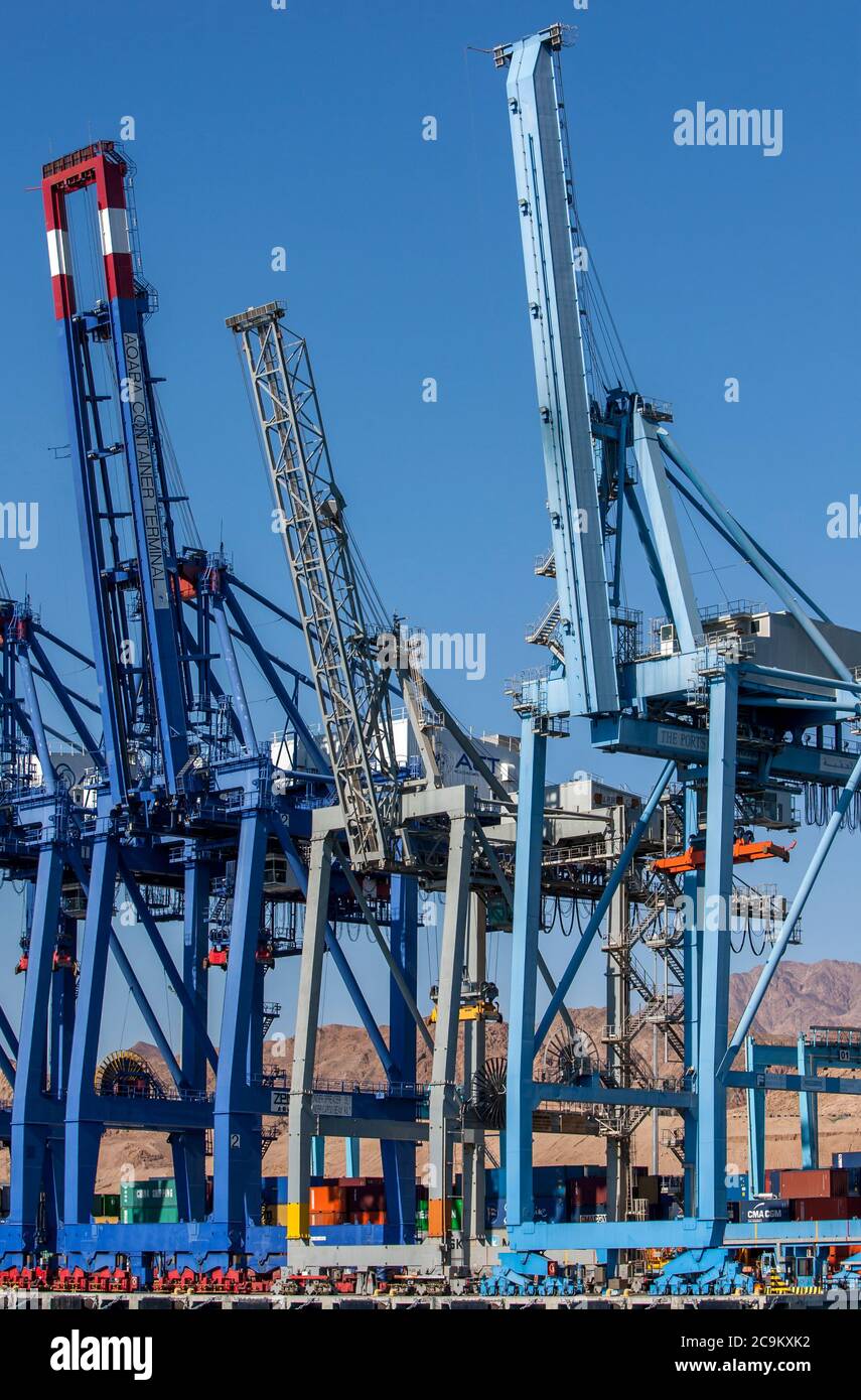 A row of huge cranes used to unload container ships of their cargo at the Aqaba Container Terminal on the Gulf of Aqaba in Jordan. Stock Photo