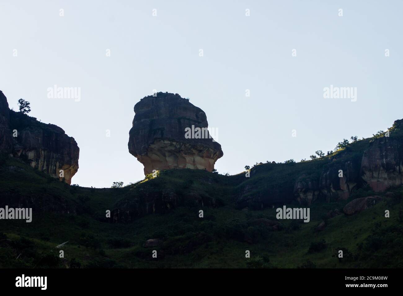 A wind  eroded Clarence sandstone formation known as the Policeman’s Helmet , in the late afternoon with light from the back, in Royal Natal, the Nort Stock Photo