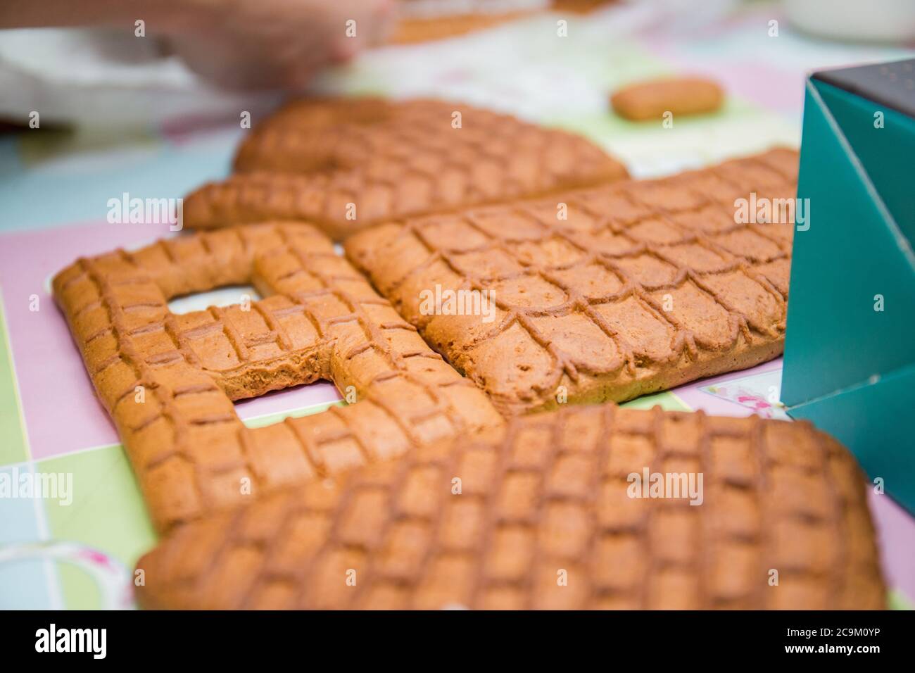 making a gingerbread house on kitchen table Stock Photo