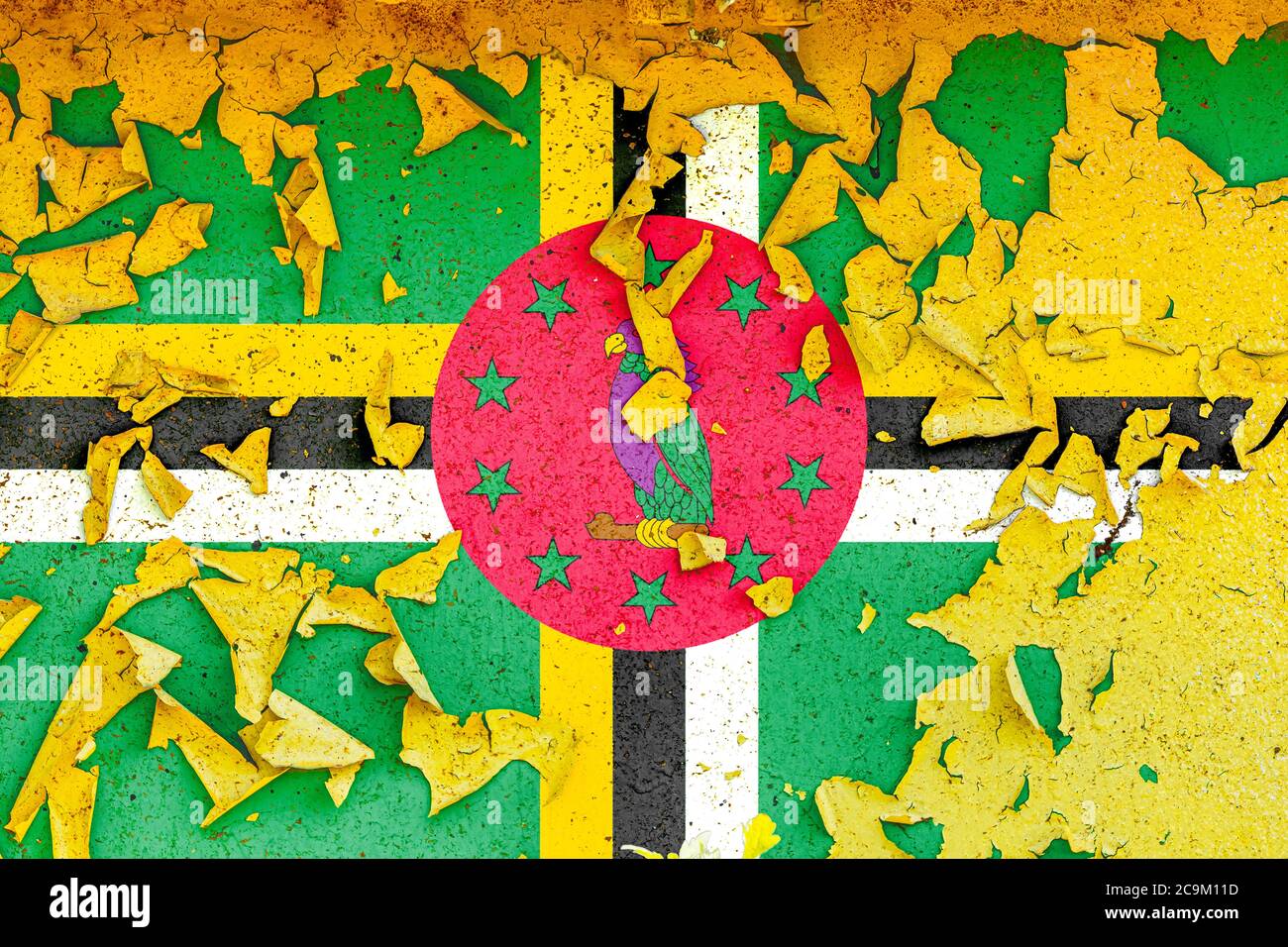 The national flag of Dominica is painted on an old metal wall with ...