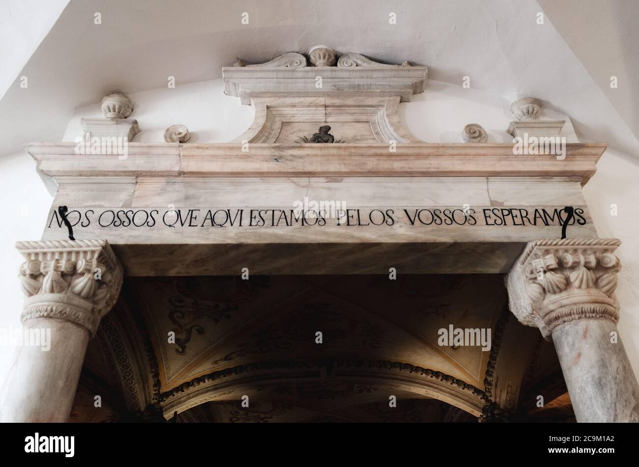 EVORA, PORTUGAL - FEBRUARY 1, 2019: Entrance portal to the Chapel of Bones in Evora, Portugal, on february 1, 2019. The portuguese message means we bo Stock Photo