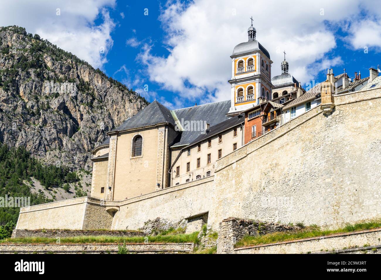 The Collegiate Church of Notre-Dame and Saint-Nicolas overlooking Briancon city walls, Huates Alpes, France Stock Photo