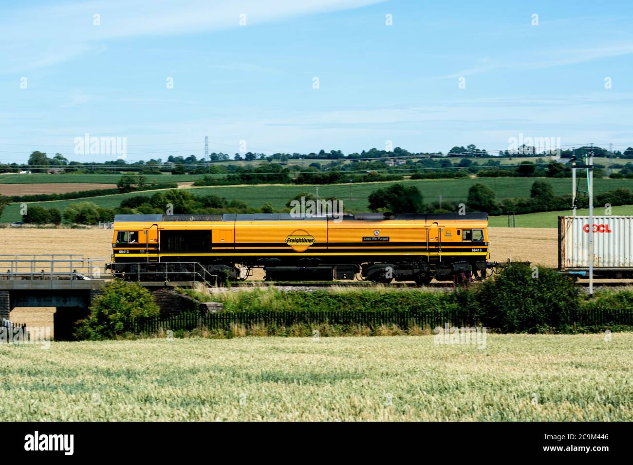 Class 66 diesel locomotive No. 66413 'Lest we forget' pulling a freightliner train on the West Coast Main Line, Northamptonshire, UK Stock Photo
