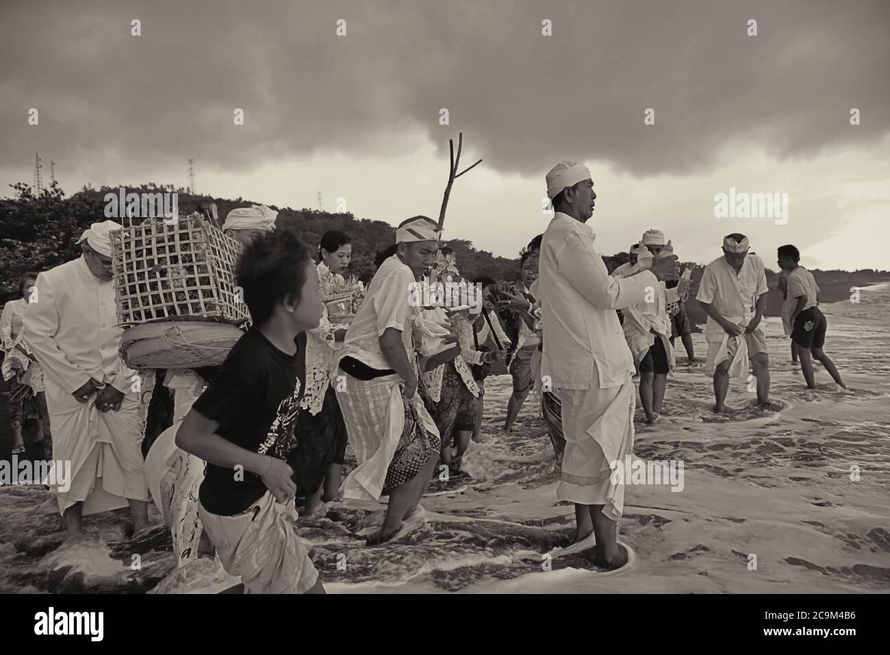 Purifying the spirits: A priest leading the members of a Balinese ...