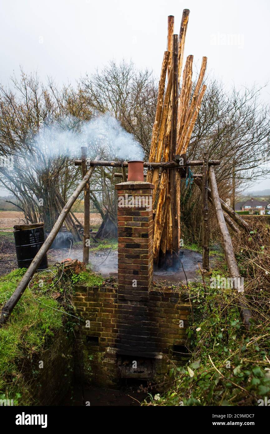 Preserving hop poles made of chestnut wood in creosote to preserve them  from rotting in the soil in the hop garden using a 100 year old tank Stock  Photo - Alamy
