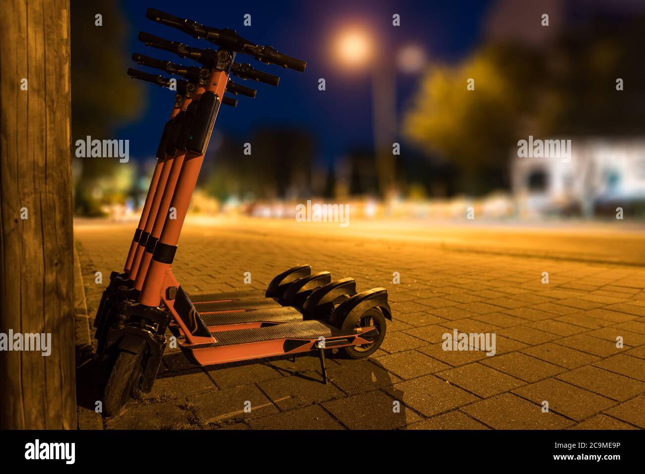 E-scooters for transport in urban environment, city at night Stock Photo