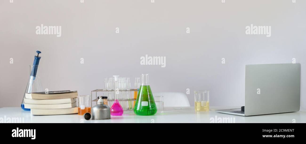 A computer laptop and various equipment are putting on the scientific