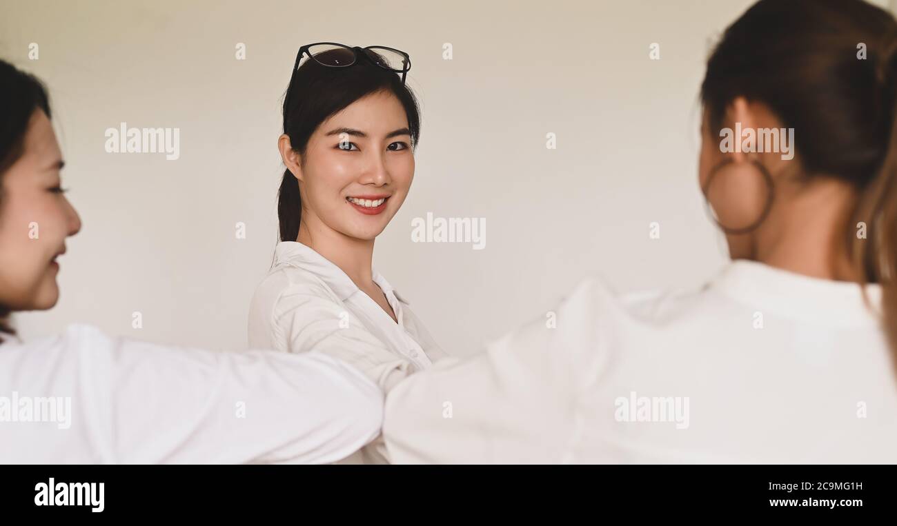 Women are greeting each other with the elbow. Elbow bumps greeting style to prevent contact and virus spread. Stock Photo