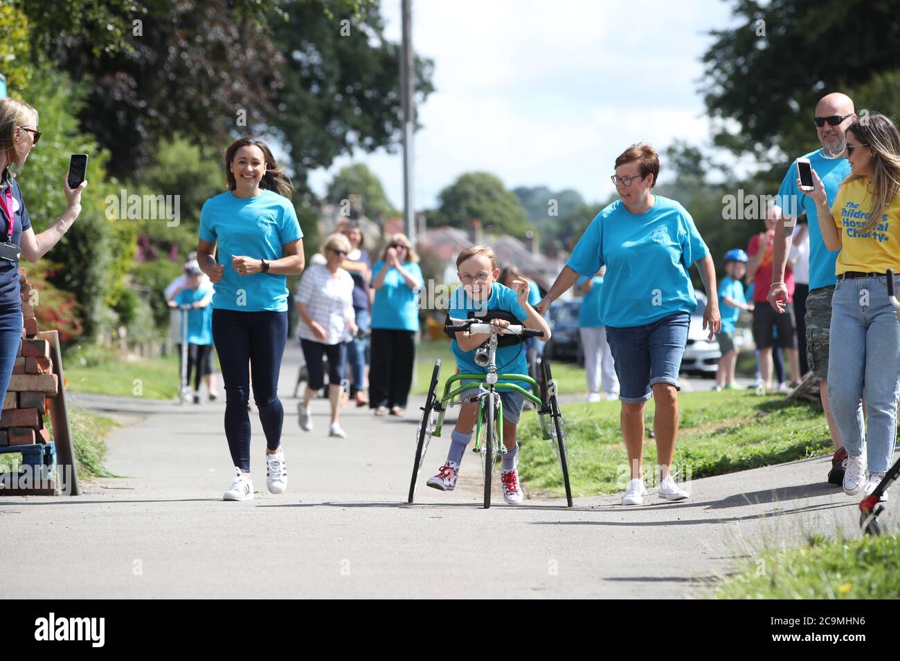 Tobias Weller, who has cerebral palsy and autism, alongside Olympic athlete Jessica Ennis-Hill (left), has nearly completed his new challenge to run a marathon in the street outside his home in Sheffield, using a race runner. Tobias, who cannot stand or walk unaided, was inspired by Captain Tom Moore to complete his first marathon on his daily walks back in April. Stock Photo