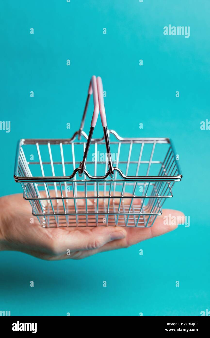 Prices for shopping consumer basket products. empty basket on a blue