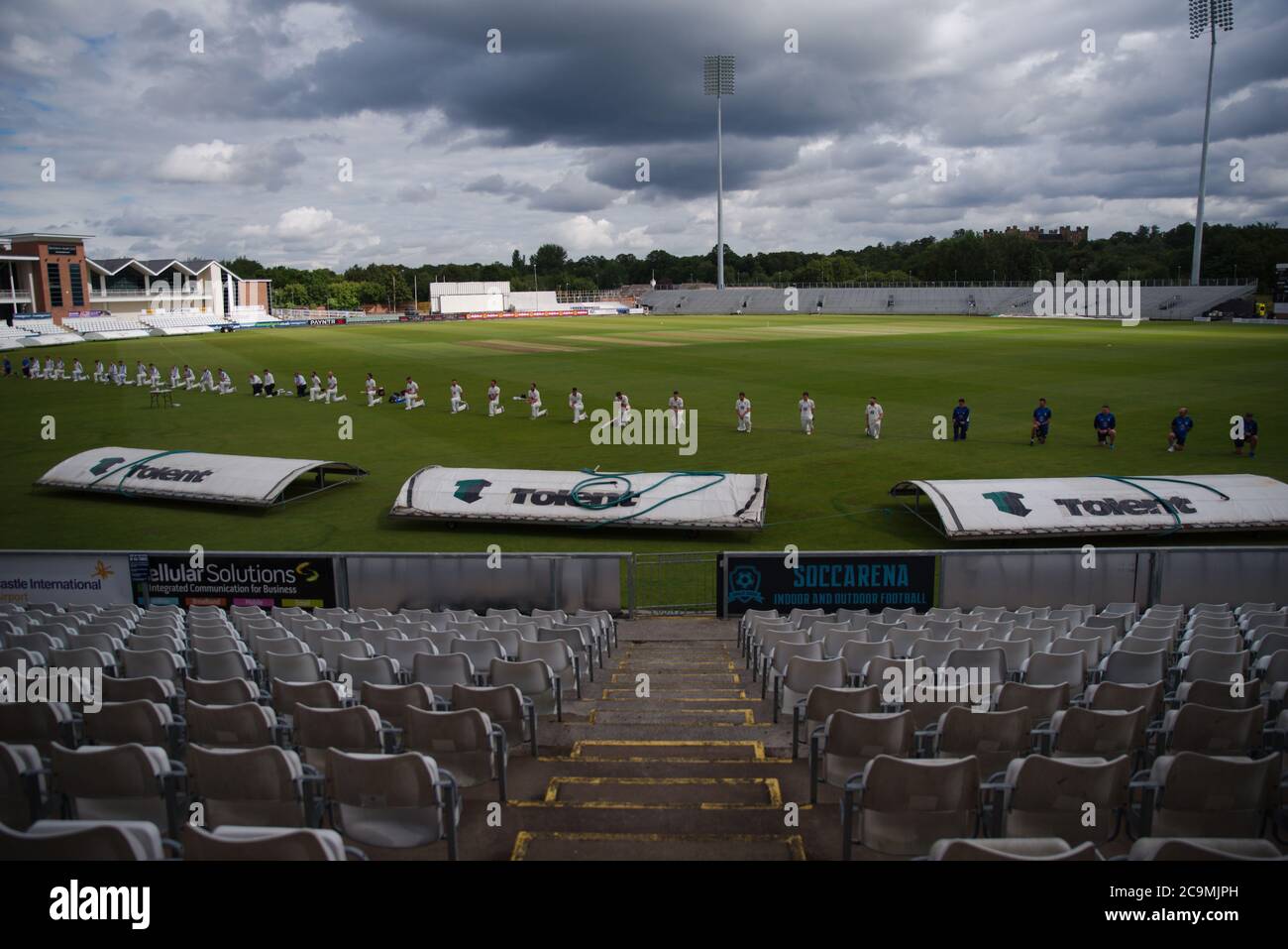 Chester le Street, England, 1 August 2020. The players of Durham and Yorkshire take the knee with the umpires before their Bob Willis Trophy match. Credit: Colin Edwards/Alamy Live News. Stock Photo