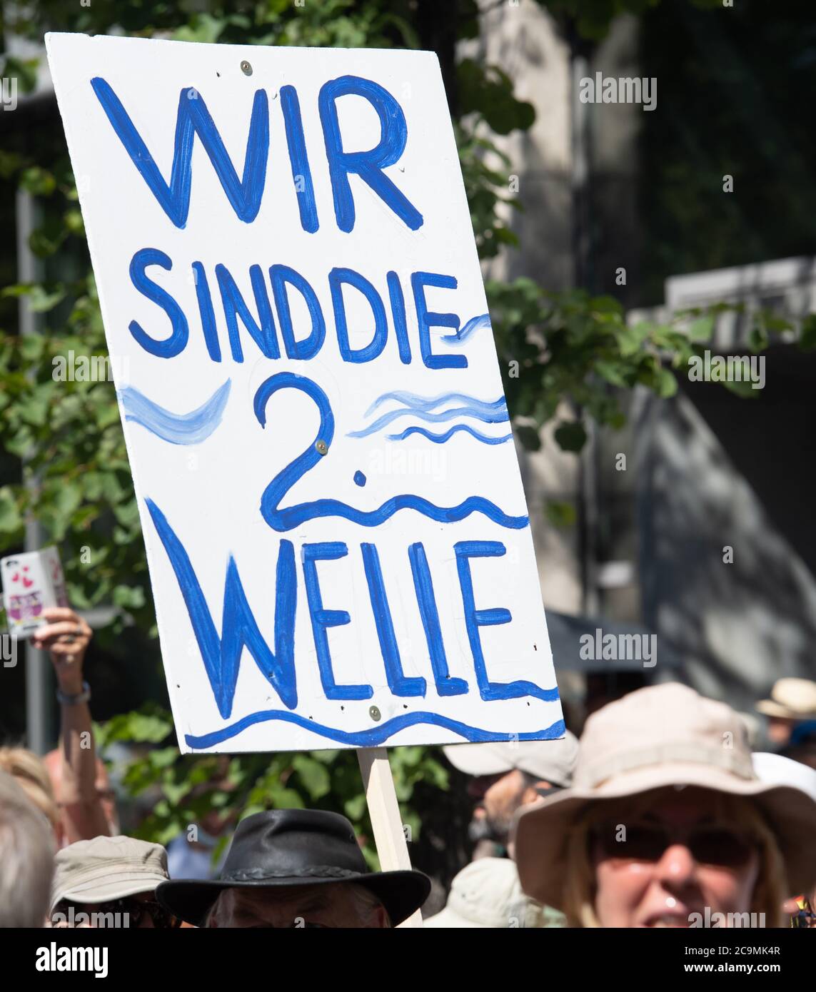 Berlin, Germany. 01st Aug, 2020. 'We are the 2nd wave' is written on a self-painted sign carried by participants in the demonstration against the Corona restrictions across the boulevard Unter den Linden. The initiative 'Lateral Thinking 711' has called for this. The motto of the demonstration is 'The end of the pandemic - Freedom Day'. Credit: Paul Zinken/dpa-zentralbild/dpa/Alamy Live News Stock Photo