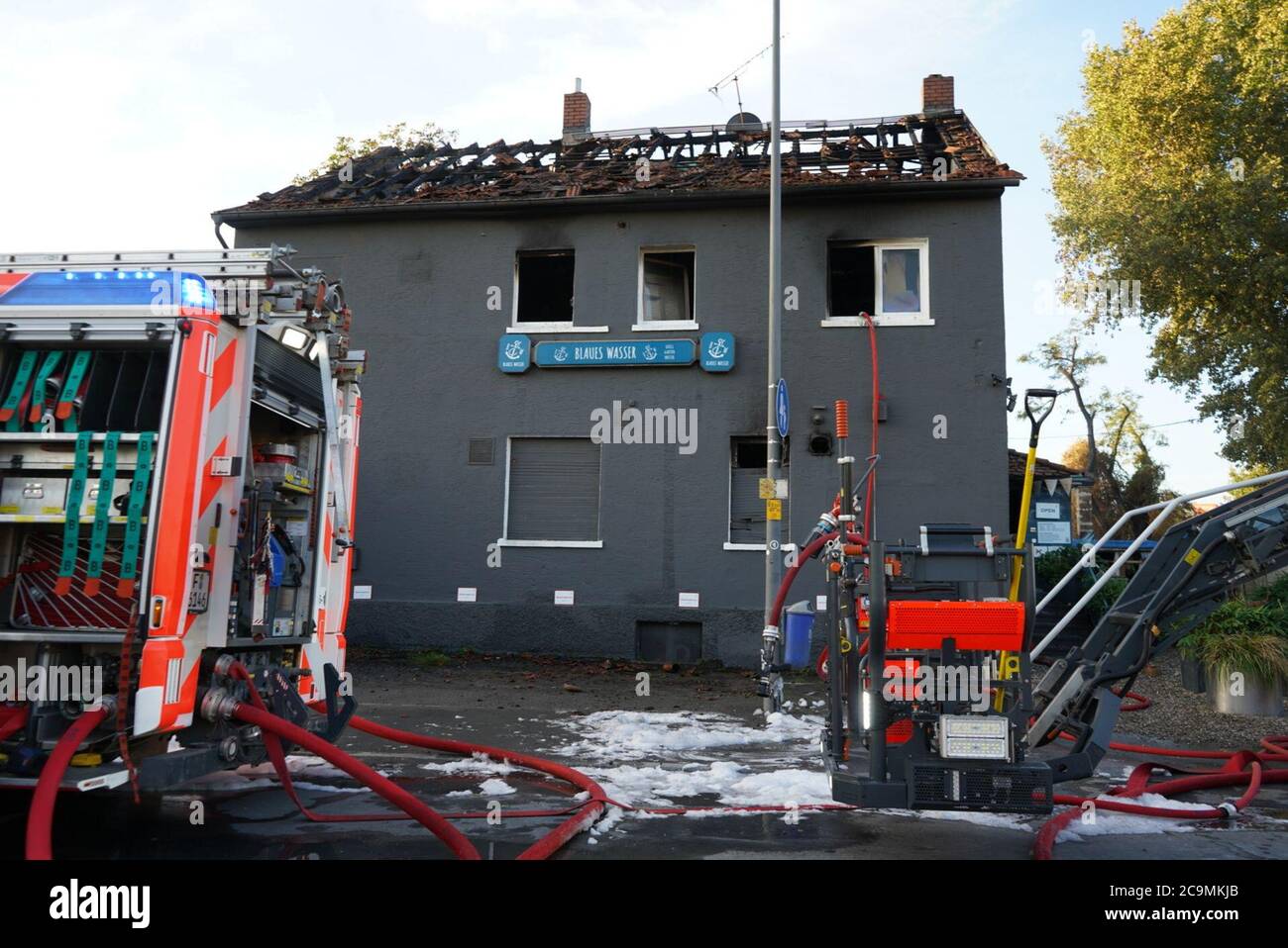 01 August 2020, Frankfurt/Main: Fire engines of the fire brigade are parked in front of the restaurant 'Blaues Wasser', which was severely damaged by a fire. The fire caused damages of about 350,000 euros. Photo: Christian Reinholz/5vision.media/dpa Stock Photo