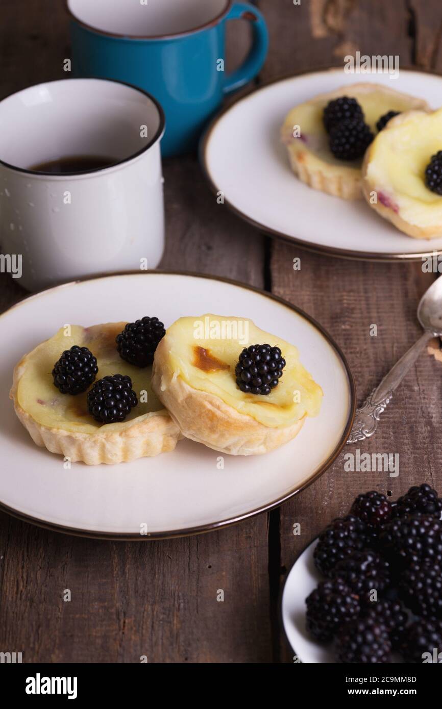 Pastel de nata famous portuguese cake with blackberries Stock Photo Alamy