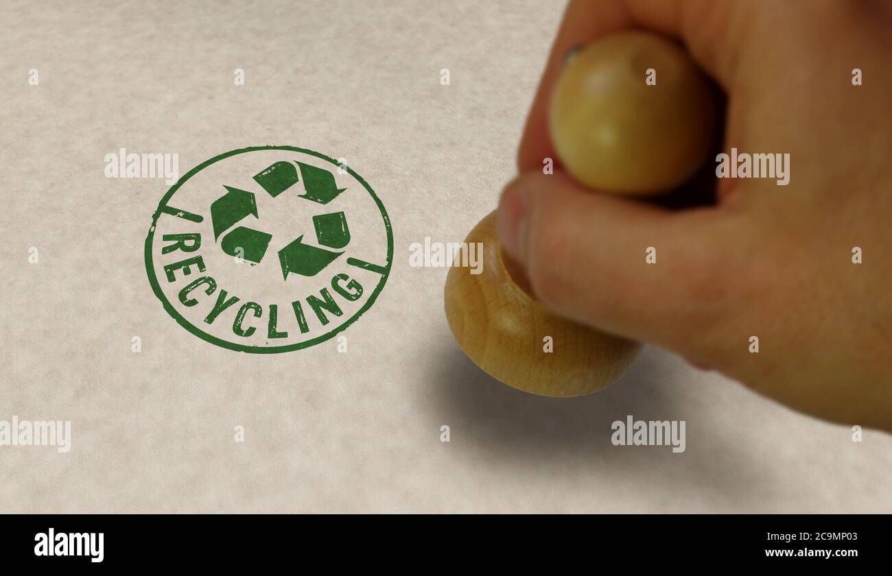 Recycling stamp and stamping hand. Recycle symbol, arrows, recyclable materials, environmental protection and earth safe concept. Stock Photo