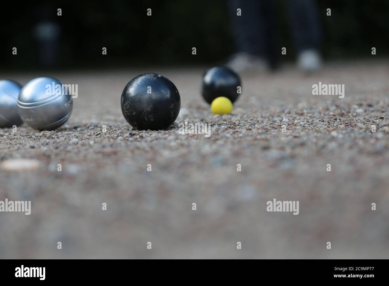 Petanque ball boules and small yellow jack on petanque field Stock