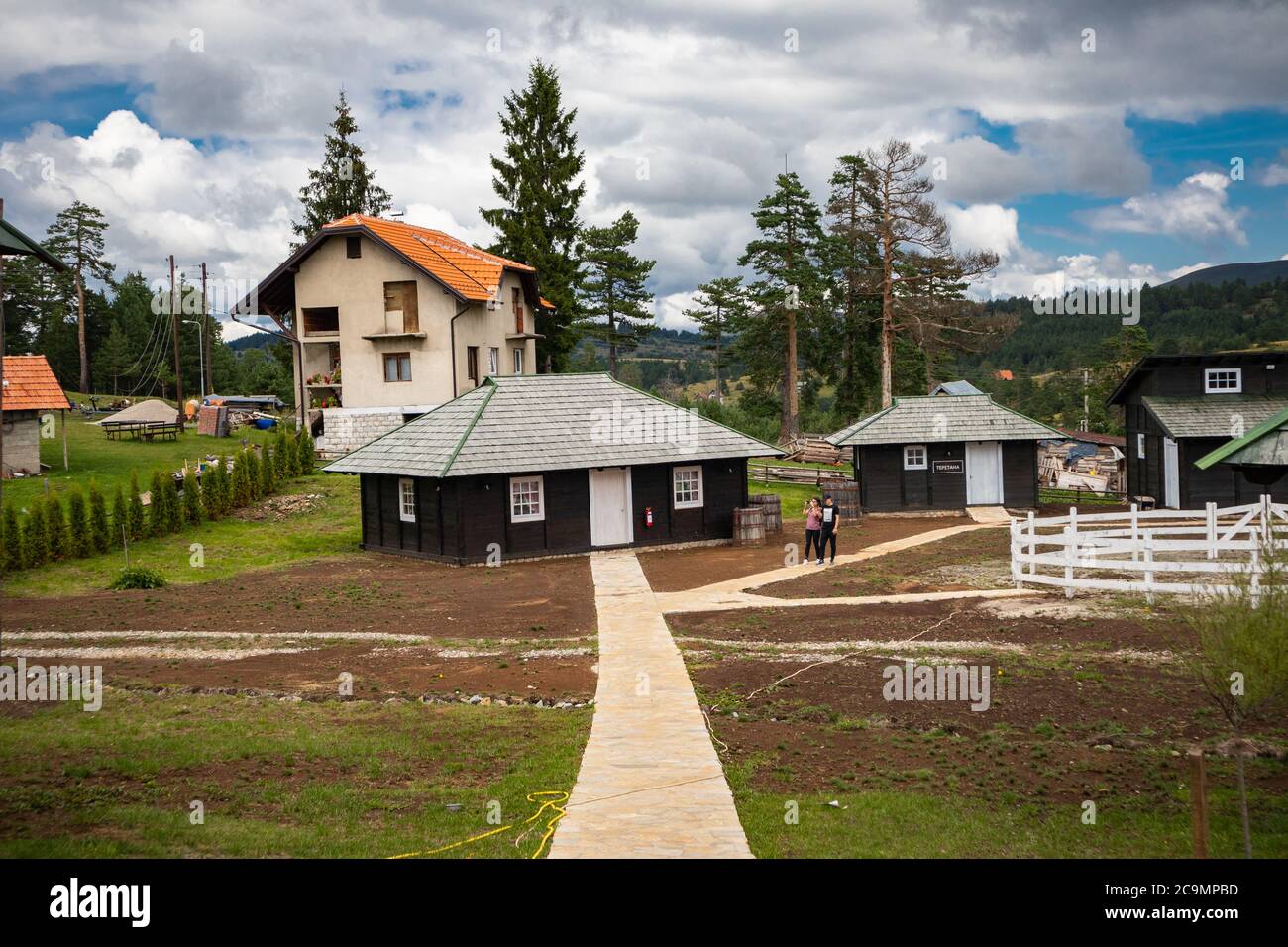 Zlatibor, Vodice, Serbia - July 26. 2020 Wooden house and walking path in the city of El Paso in old Serbian style. Serbian thematic park. Stock Photo
