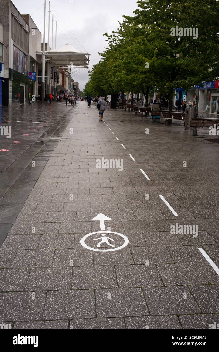 Southampton city centre one way system pavement signs for social distancing in the High street shopping district during the Covid-19 pandemic crisis. Stock Photo