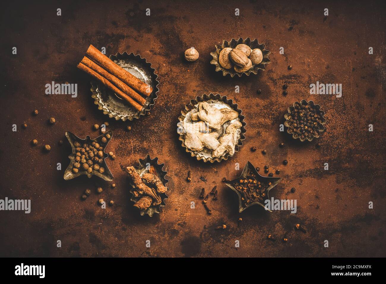 Flat-lay of Turkish spice Yedi Bahar mix over rusty background Stock Photo