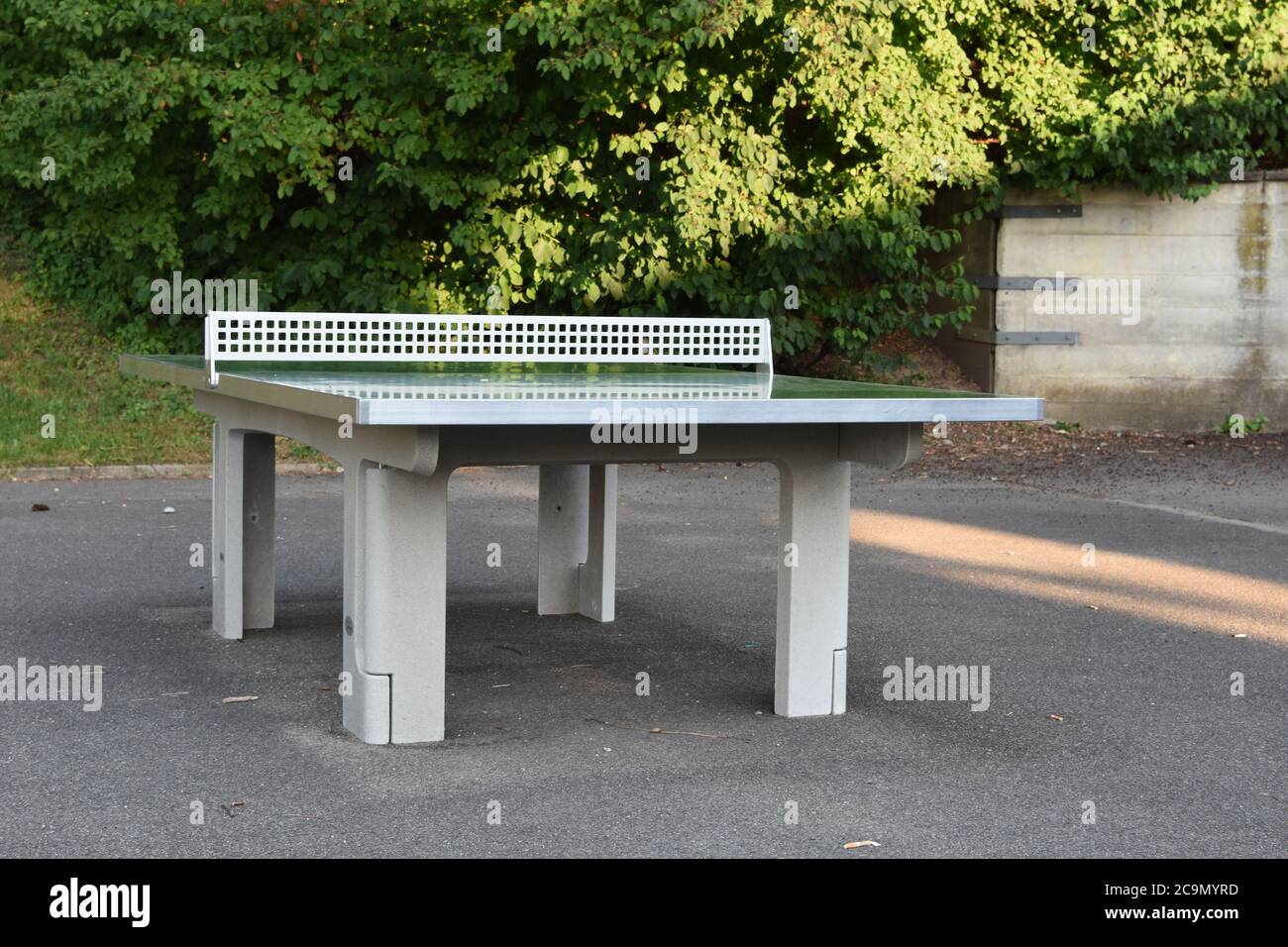 Table for table tennis made from synthetic material in school playground abandoned due to corona virus and Covid-19. Stock Photo