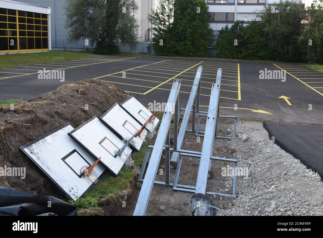 Basketball stands dismantled on a sport field due to collective sport collapse since coronavirus crisis. Social distancing and other prevention. Stock Photo