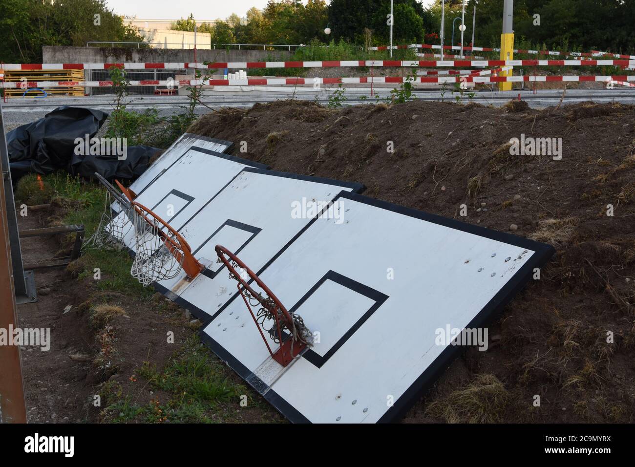 Basketball boards uninstalled from the stands and put on the ground due to reconstruction of sport field during coronavirus. Stock Photo