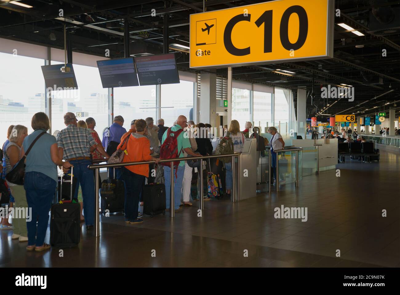 AMSTERDAM, NETHERLANDS - SEPTEMBER 17, 2017: Passengers are queuing for boarding a plane in the departure area on the Schiphol Airport Stock Photo