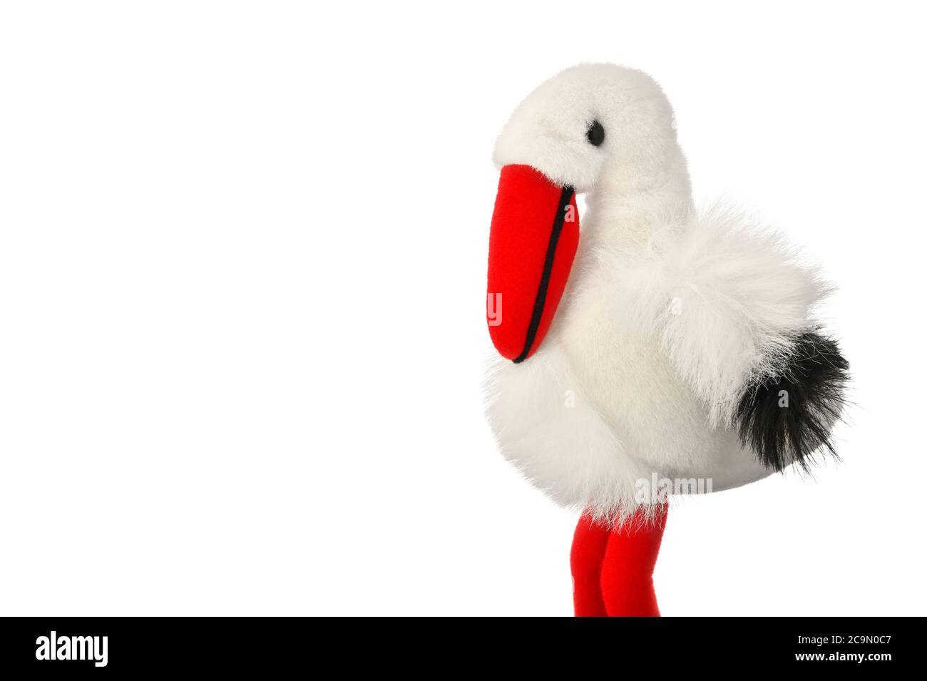Typical souvenir from Alsace, France. Soft toy white stork bird (Ciconia ciconia) isolated on white background with copy space. Stock Photo