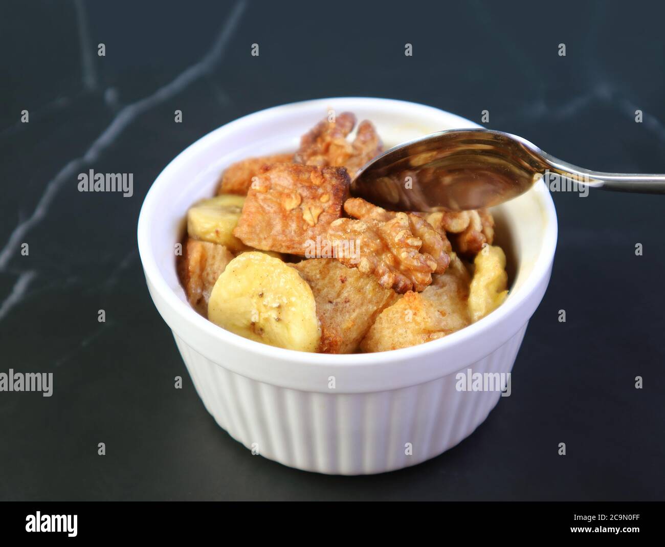 Closeup Mouthwatering Banana Walnut Bread Pudding in a Ceramic Bowl