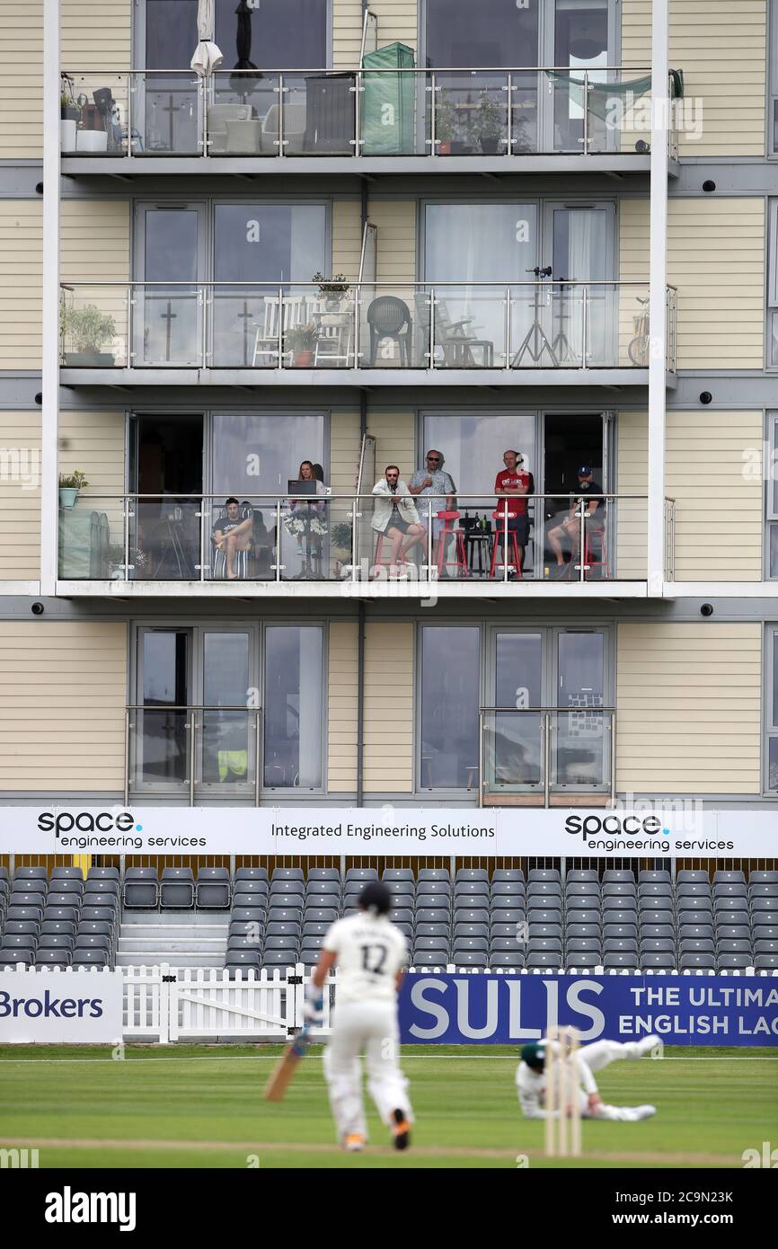 Members of the public watch the action from flats overlooking the