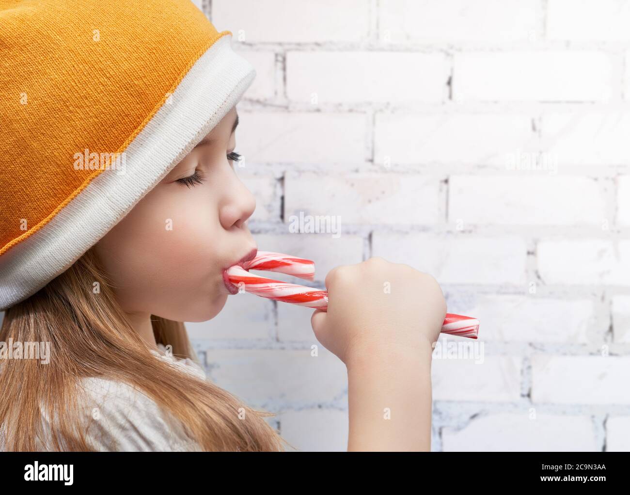 little girl eats a candy bar Stock Photo