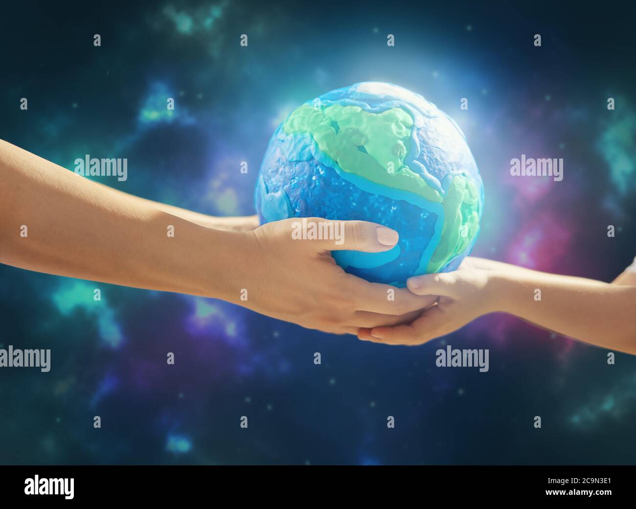 Child and adult holding planet in hands against space background. Earth ...