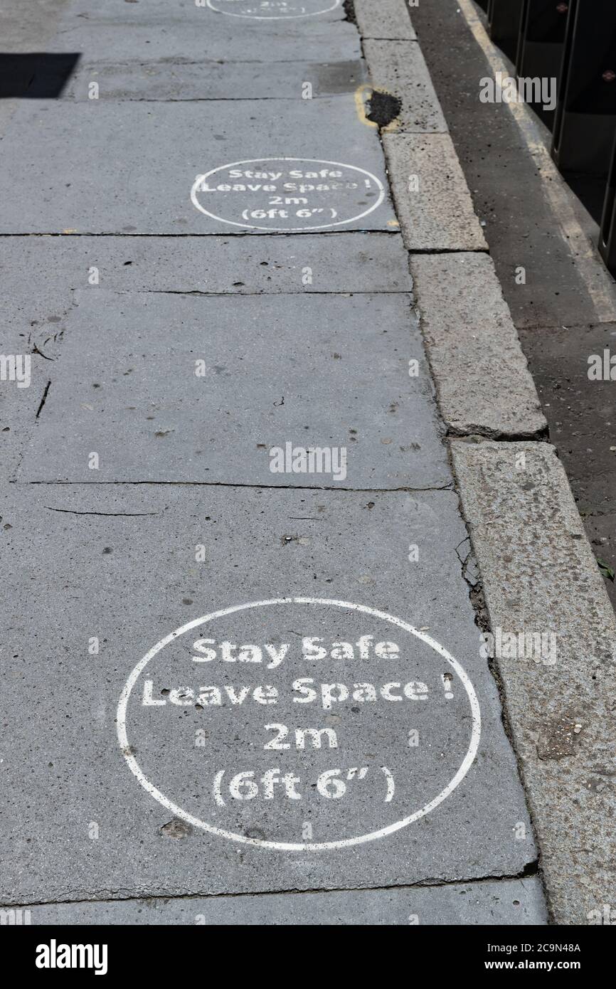 Social distancing markings on a pavement Stock Photo