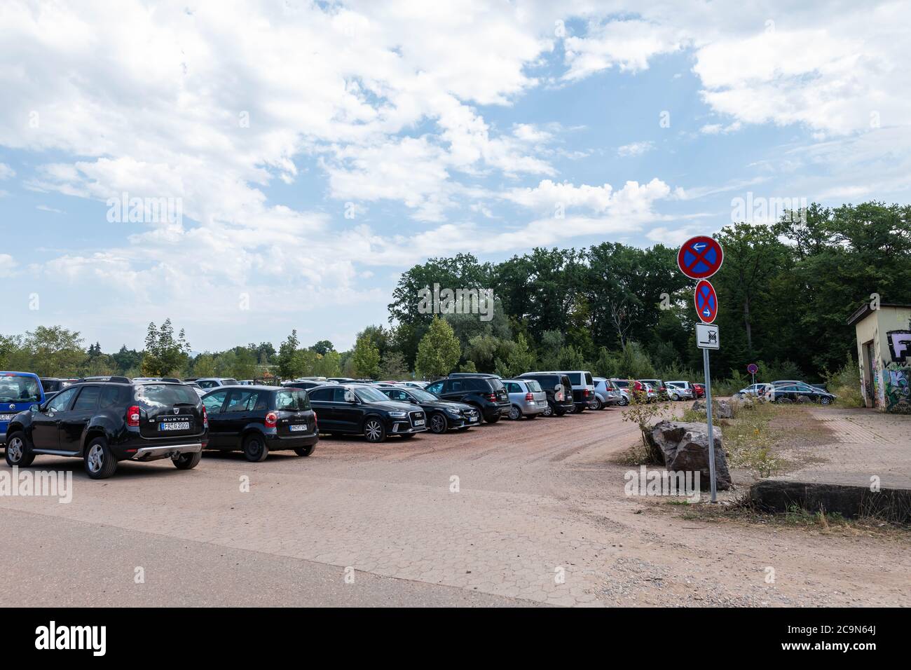 Freiburg, Germany. 01st Aug, 2020. A sign indicates an absolute prohibition  to stop at an access road to Lake Opfingen, while in the background there  are correctly parked cars. On the hottest